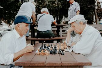 Seniors playing chess in the park